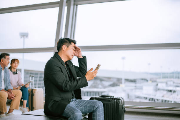 malaysia,businessman,airport,problem,bad news - waiting telephone on the phone anxiety imagens e fotografias de stock