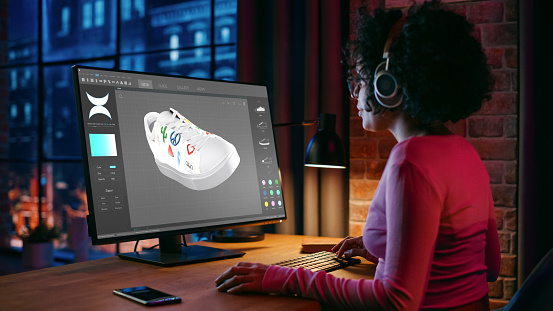 Smart Black Footwear Designer Creating 3d Model of Shoe While Working on PC in Creative Space During Evening. Female Teenager in Glasses Developing New Design. Shoe Production Procedure Concept.