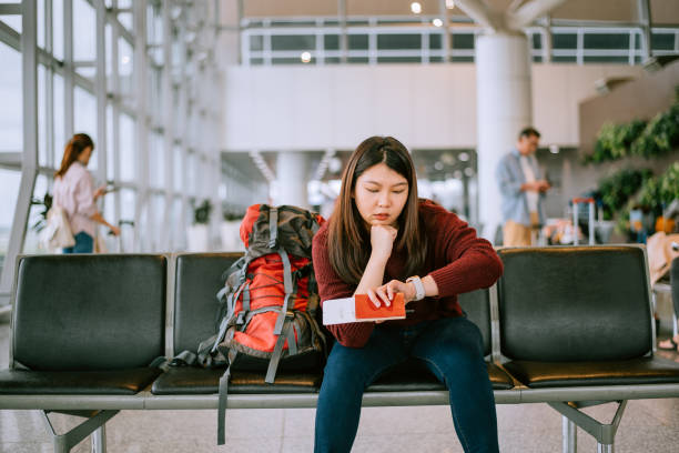 Bored Woman with backpack in Airport Waiting Room stock photo