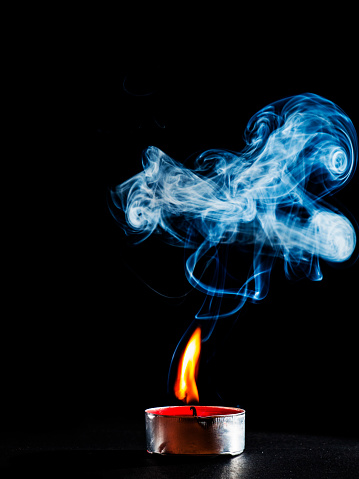 Smoke Of Matchstick On Candle Flame