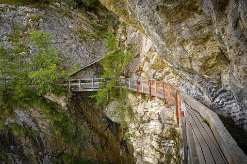Adrenaline walking trail following historic irrigation channel on the cliffs Bisse du Ro close to Crans Montana in Switzerland