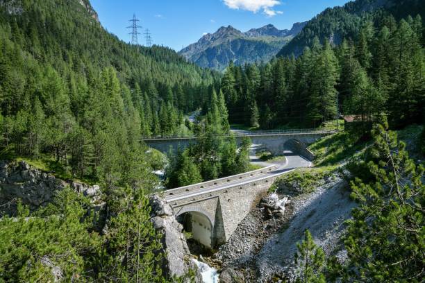 Albula high mountain pass road leading along famous Albula line railway between Bergun and Preda in Swiss Alps