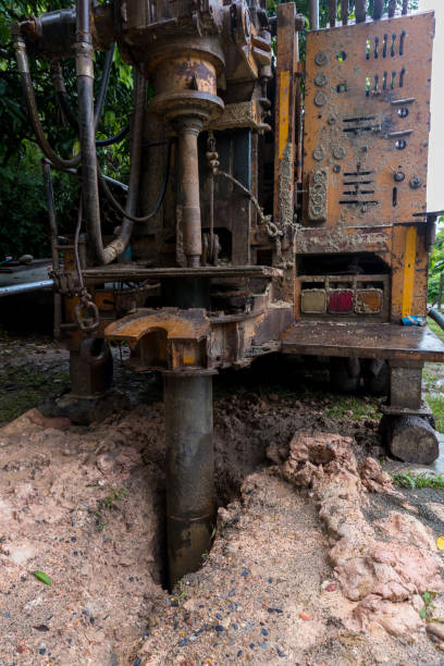 istock Ground water hole drilling machine installed on the old truck. Ground water drilling machine installed in rural 1408853676
