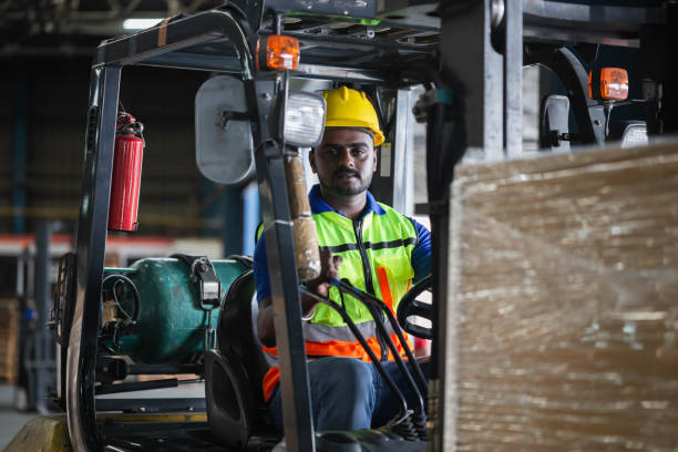 istock Worker on forklift, Manual workers working in warehouse, Worker driver at warehouse forklift loader works 1408853769