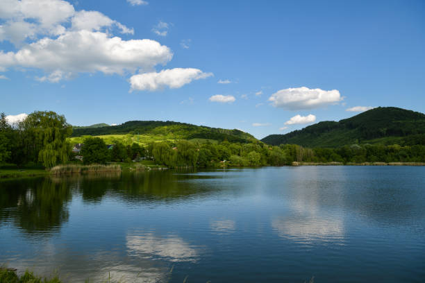 Kuchyna, Slovakia - May 22, 2022: Kuchyna lake with Little Carpathians in background in small village of Kuchyna in Slovakia during spring 2022