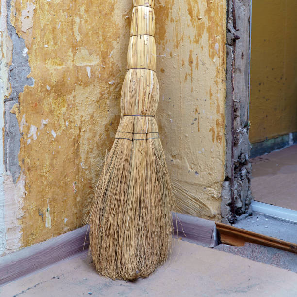 istock A straw broom stands in a corner against shabby wall 1408854816