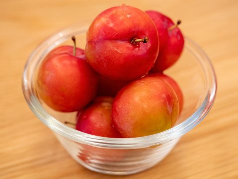 Close-up of plums in glass bowl