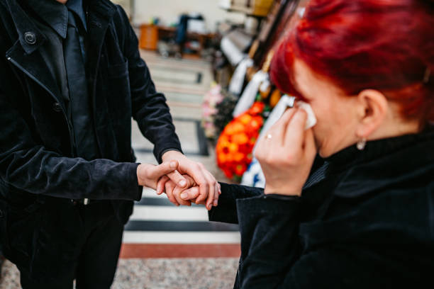 istock Son comforting his mother in funeral parlor 1408856979