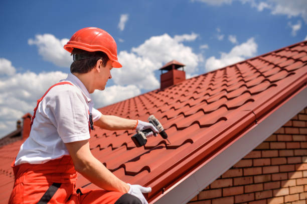 istock Man worker master in red overall and helmet is fixing the metal tile roof. 1408857221