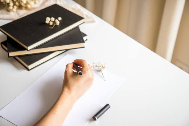 istock White table with some books, sheets and pen. Conceptual image, representation of creativity, knowledge and leisure. 1408857295