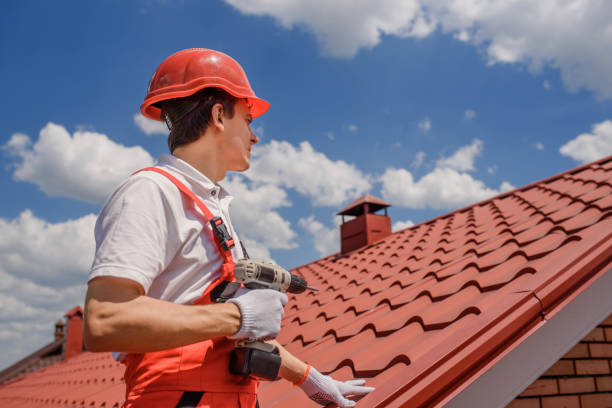 man worker master in red overall and helmet is fixing the metal tile roof. - roof tile architectural detail architecture and buildings built structure imagens e fotografias de stock