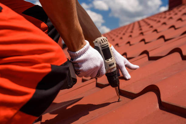worker master hands holding an electric screwdriver and fixing the metal tile roof. - roof tile architectural detail architecture and buildings built structure imagens e fotografias de stock