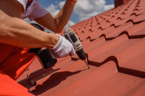 istock worker master hands holding an electric screwdriver and fixing the metal tile roof. 1408858022