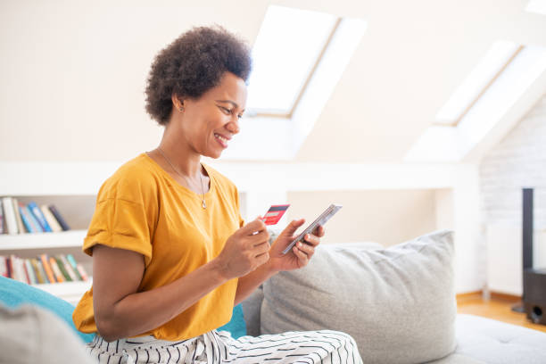 istock Cheerful  woman doing online shopping 1408859479