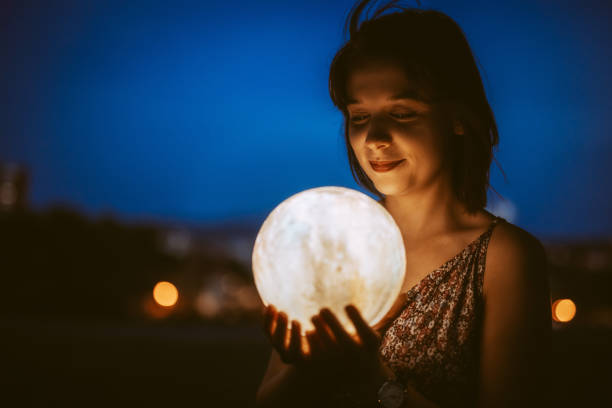 istock Young Woman With A Moon Light Lamp 1408861086