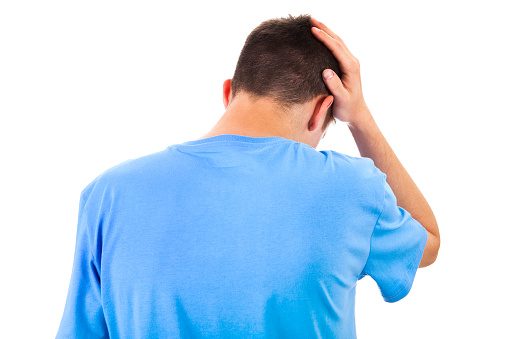 Rear View of the Sad Young Man Isolated on the White Background