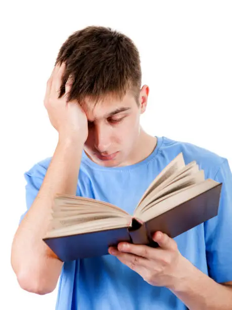 Tired Young Man with a Book Isolated on the White Background