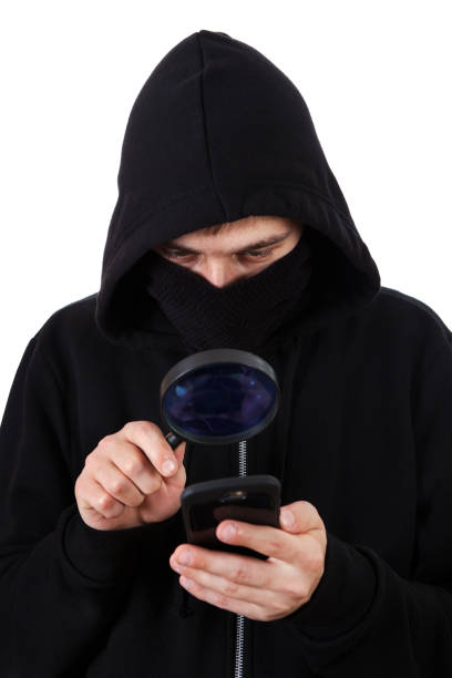 hacker with a magnifying glass - snooper imagens e fotografias de stock