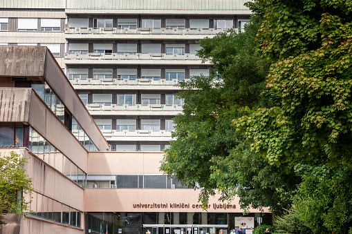 Picture of the main Slovenian hospital, univerzitetni klinicki centar ljubljana, the university clinical centar, zith a focus on its entrance and its main facade.