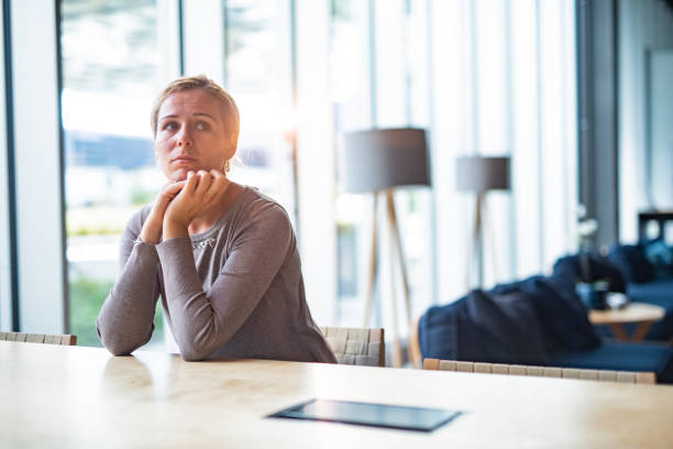 istock Pensive woman sitting alone in cafe 1408864776