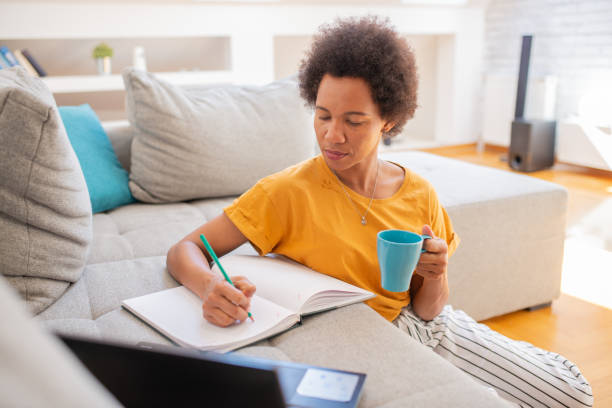 istock Mid adult woman working from home 1408866404
