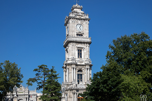 Dolmabahce palace historical clock tower.Baroque style architecture.Istanbul,Turkey.6 July 2022