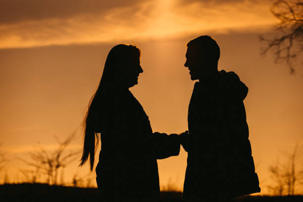 istock Young Couple Holding Hands In Silhouette 1408868048