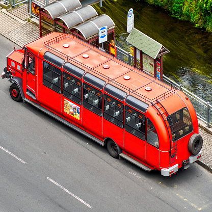 Hrensko, Czech Republic, June 28, 2022: Aerial view of a red historical bus used for sightseeing tours by tourists