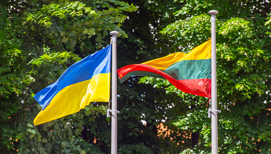 Flags of Ukraine and Lithuania on flagpole in a street, Vilnius