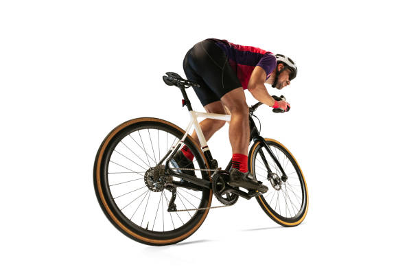 istock Portrait of man, professional cyclist training, riding isolated over white studio background. Rear view 1408874477