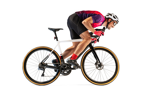 Portrait of man, professional cyclist training, riding isolated over white studio background. Developing speed. Concept of sport, action, motion, speed, hobby, lifestyle. Copy space for ad