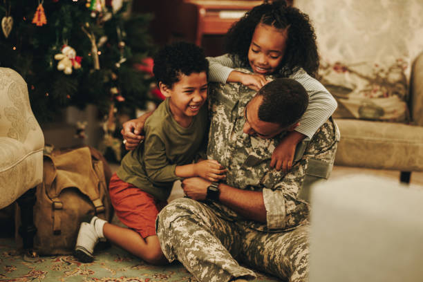 istock Army soldier playing with his kids at Christmas 1408874689
