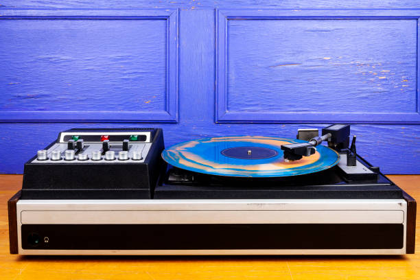 istock Vintage turntable vinyl record player with blue and orange vinyl 1408877556