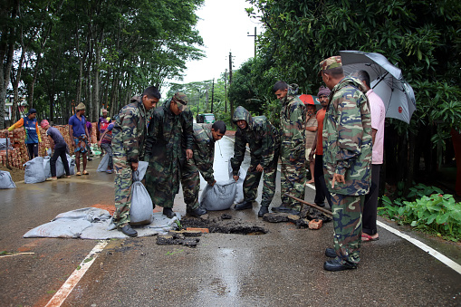 The army members are working to repair the roads damaged by the flood. Floods in Sylhet due to heavy rainfall caused by climate change. And since the roads were damaged, the army members are helping in the repair work. Photo taken from Sunamganj at Sylhet Division in Bangladesh on 6 July 2022.