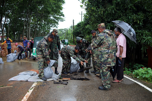 The army members are working to repair the roads damaged by the flood. Floods in Sylhet due to heavy rainfall caused by climate change. And since the roads were damaged, the army members are helping in the repair work. Photo taken from Sunamganj at Sylhet Division in Bangladesh on 6 July 2022.