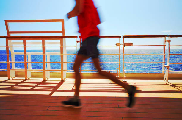 istock Motion blurred runner exercising on the sunny deck of a cruise ship with a blue Mediterranean sea in the background 1408881849