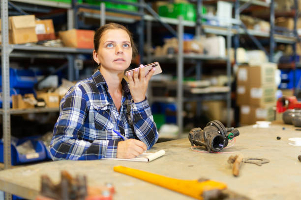 istock Young woman warehouse worker talking on phone 1408882747