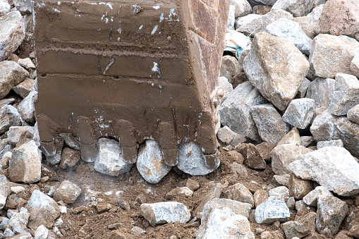 iron excavator or macro truck working in house construction site separate rocks