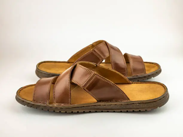 Photo of Male brown leather sandals. Close up on the white background.