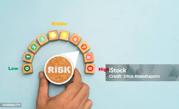 Investor Hand Turning Risk Button From Low To High Position For Risk Management Survey And Analysis Of Business Investment Concept Stock Photo - Download Image Now