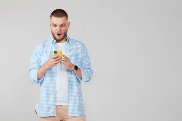 istock handsome man with mobile cell phone surfing internet 1408888370