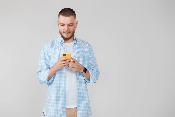 istock handsome man with mobile cell phone surfing internet 1408888379