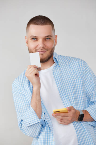 istock handsome man with smartphone and credit card 1408888462