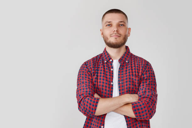 istock smiling young guy posing with crossed arms 1408888526