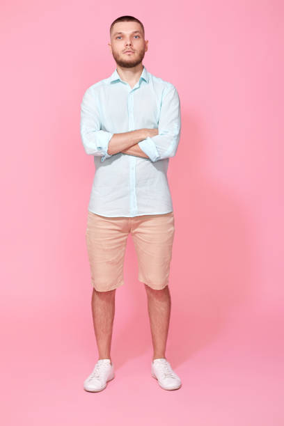 istock young caucasian man holding hands crossed looking camera 1408888550