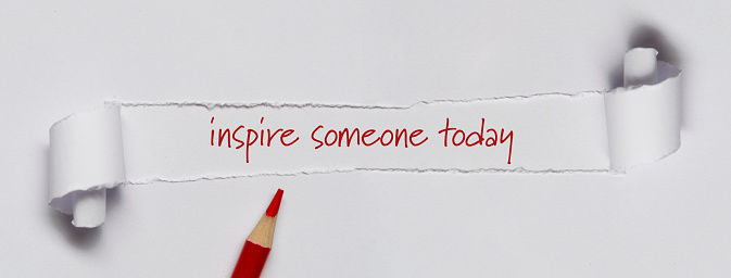 Inspire someone today written under torn paper.