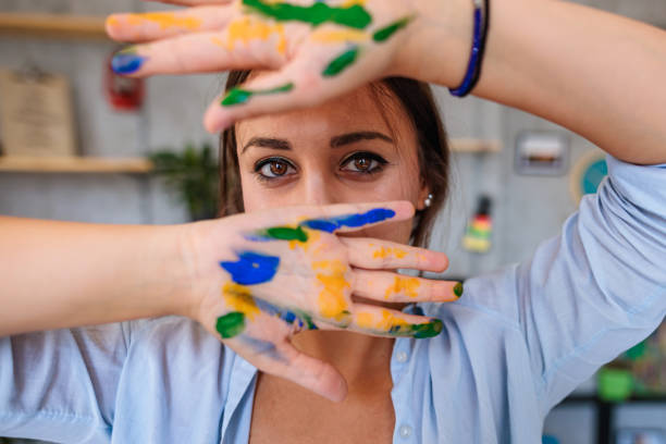 istock Female artist with painted hands 1408893285