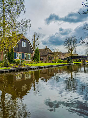 Giethoorn, Netherlands - November 9, 2019: Giethoorn is a town in the province of Overijssel, Netherlands with a population of 2,620. It is located in the municipality of Steenwijkerland, about 5 km southwest of Steenwijk. As a popular Dutch tourist destination both within Netherlands and abroad, Giethoorn is often referred to as \