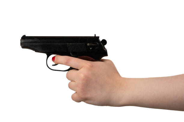 istock A young woman pulls the trigger of a Makarov pistol. 1408894568