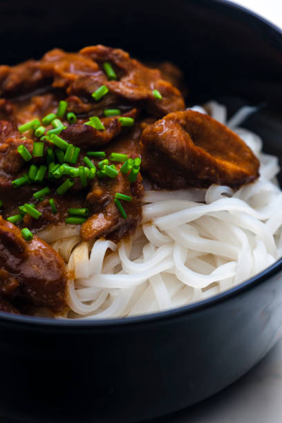 istock meat with sauce served with rice noodles 1408895322